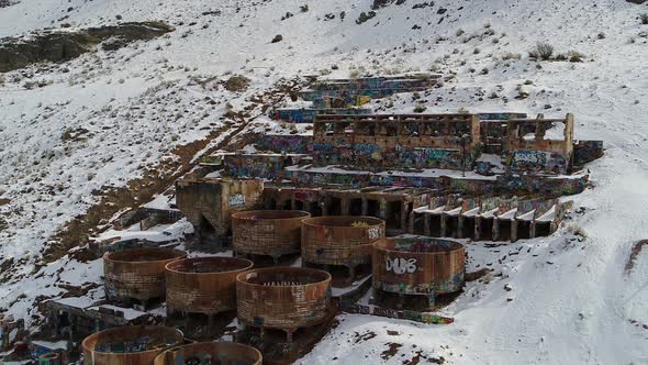 A drone orbits the rusty Old Tintic Mill in Geneloa, Utah, revealing the decaying water tanks, leach