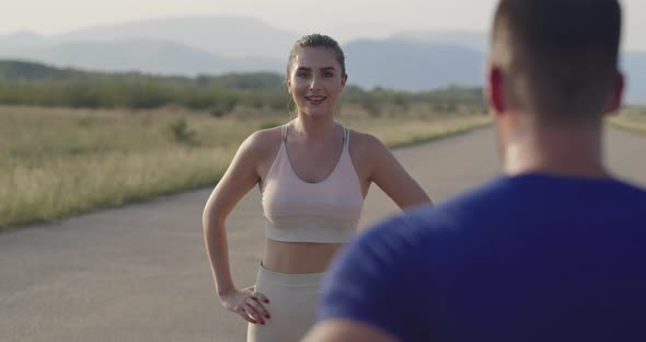 Multiethnic Group of Athletes Stretching Together on a Panoramic Road