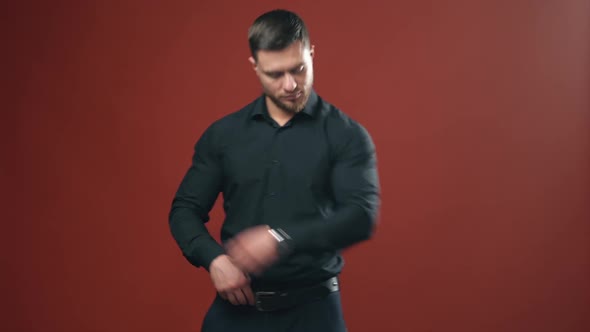 Handsome man with strong body in a dark shirt preparing and having look at the camera.