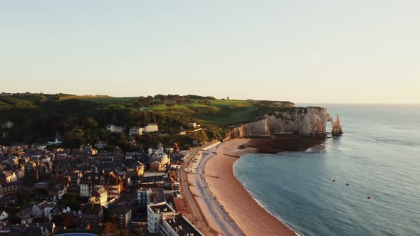 A Town Located on the Coast Among Sheer Cliffs with a Natural Arch