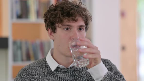 Portrait of Young Man Drinking Water