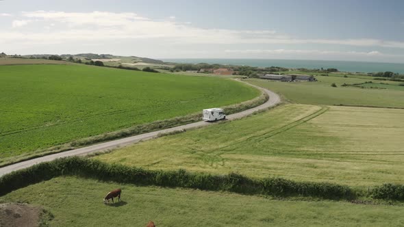 Aerial view of motorhome on country road.