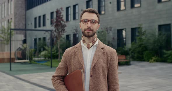 Portrait of Male Person in Glasses Turning Head and Smiling While Looking To Camera