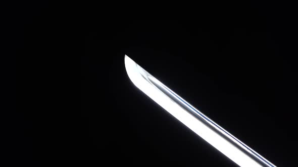 Dramatic Studio Shot of Man Holding Samurai Sword. Close Up