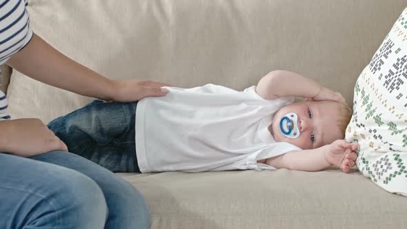 Sleepy Baby Lying on Sofa