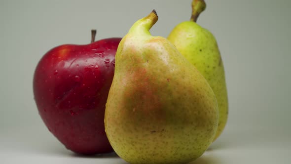 A Red Delicious Apple And Two Heart Shaped Pear On A White Background - Close Up Shot