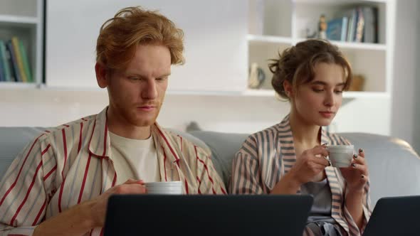 Working Couple Drinking Coffee at Home Office Closeup