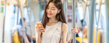 Banner, web page or cover template of Young Asian woman passenger using and listening music