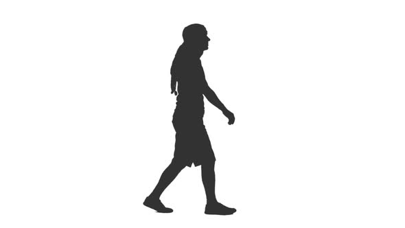 Silhouette of Man Tourist Walks in Shorts and Arabic Scarf