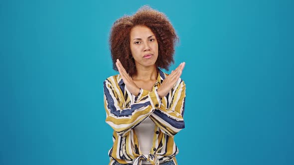 African American Lady Crosses Hands Showing Stop Gesture