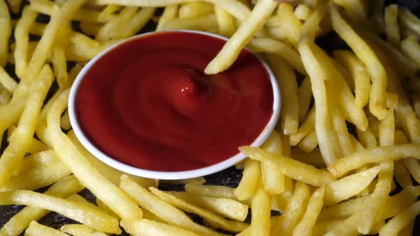 Customer dip the french fries in tomato sauce.