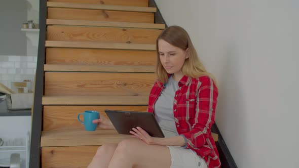 Portrait of Freelance Woman with Tablet Pc on Stairs Working on Project