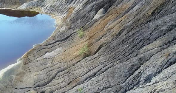 Close Motion Above Quaint Petrified Slopes of Old Clay Pit