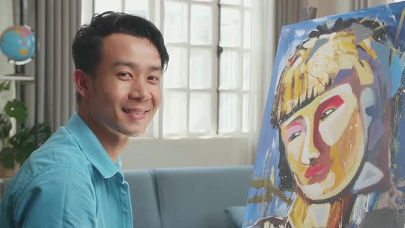 Asian Artist Man In Wheelchair Holding Paintbrush Mixed Colour Turn To Smile While Painting