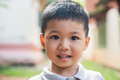 Close up portrait of asian boy smiling in the park. - PhotoDune Item for Sale