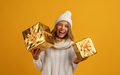 woman holding golden present boxes celebrating new year - PhotoDune Item for Sale
