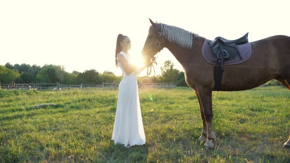 Brunette with Ponytail Pets Brown Horse Mane on Meadow