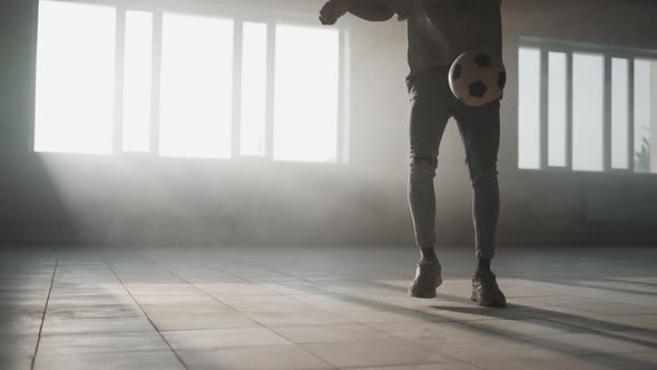 Black Boy Football Soccer Player Practicing Tricks Kicks and Moves with Ball Inside Empty Covered