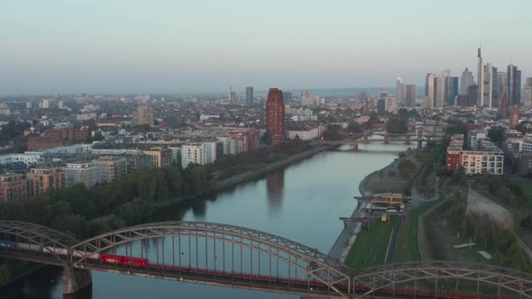 Empty Cargo Train Going Over Bridge on Main River in Frankfurt Am Main with Skyscraper Skyline View