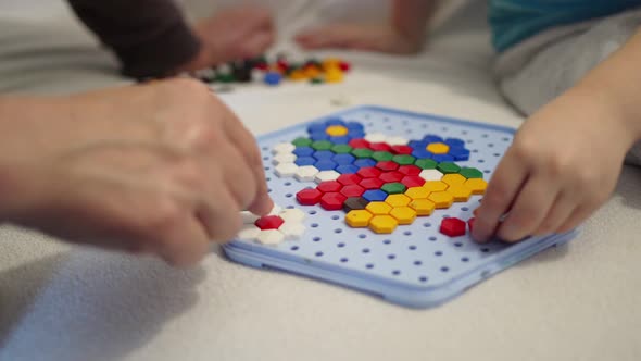 Hands of an Adult and a Child Collect a Mosaic on a Plastic Supply Games Preschooler Development