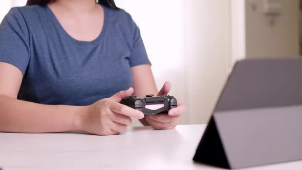 Teenager girl pressing joystick buttons in game competition, gadget addiction