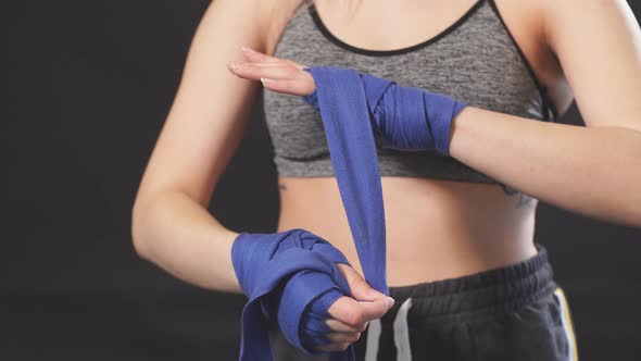Handsome Caucasian Blonde Woman Wrapping Her Hands with Wraps for Boxing