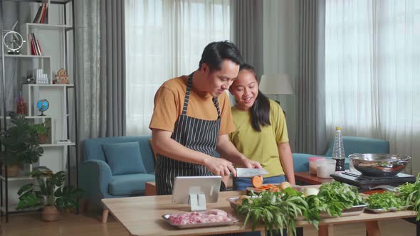 Funny Asian Man Father And Daughter Dancing Together While Cooking At Home