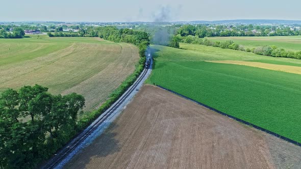 Aerial View of a Steam Engine Puffing Smoke and Steam with Passenger Coaches