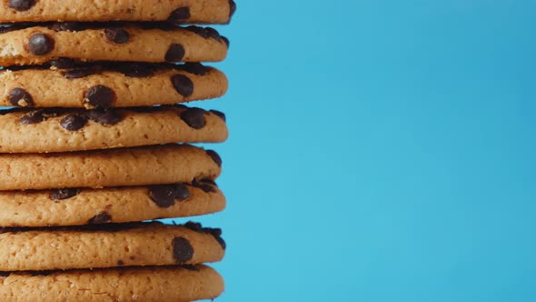 A Stack Chocolate Chip Cookies Rotate on a Blue Background