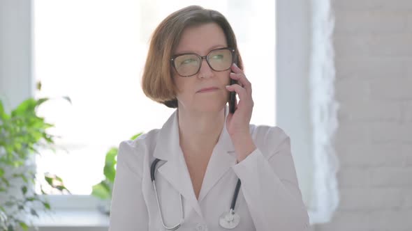 Portrait of Senior Female Doctor Talking on Phone