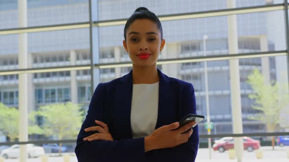 Businesswoman standing with arms crossed in the office 4k