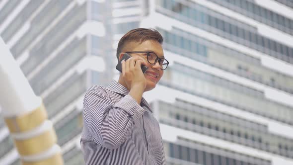 Portrait Asian businessman answers the phone.