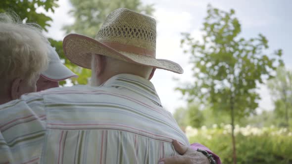 Two Cute Mature Couples Hugging in the Park Together Standing in Circle