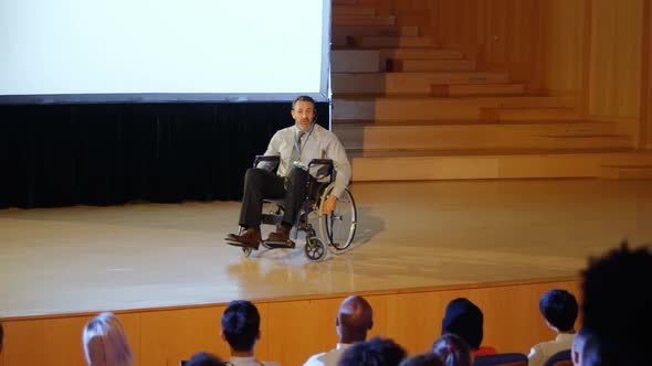 Businessman speaking on stage in auditorium 4k