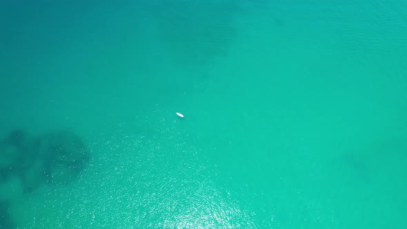 A Lonely White Supboard in the Middle of the Ocean