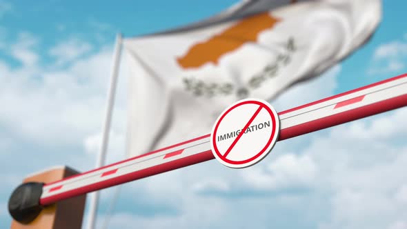 Opening Barrier with Stop Immigration Sign at the Cypriot Flag