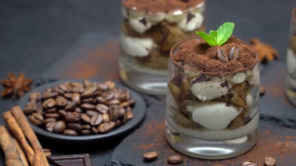 Classic Tiramisu Dessert in a Glass on Stone Serving Board on Dark Concrete Background