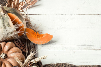 Autumn background with decorative items and pumpkin.