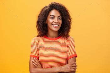 Waist-up shot of creative ambitious good-looking female coworker in trendy striped t-shirt holding / Photodune, Misc