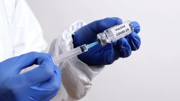 Doctor Fills Injection syringe with Vaccine COVID-19 Close-Up