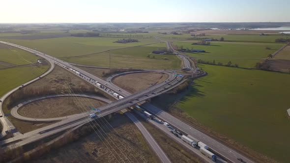 Aerial view of freeway intersection with moving traffic cars.