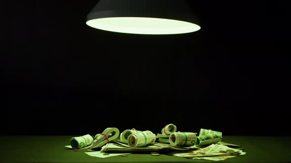 Money on Table Closeup Cash Illuminated with Green Light
