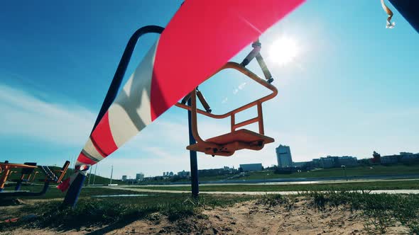 Swaying Swings with a Warning Tape Around Them