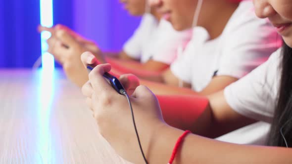 Hands Of Asian Team Gamers Playing In Competitive Video Games By Mobile Phone