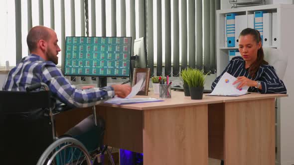 Businessman in Wheelchair Working in Corporate Office