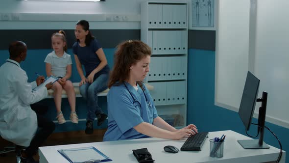 Portrait of Medical Assistant Working on Appointment Service