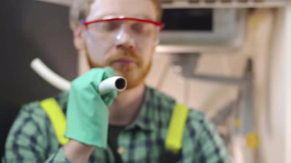 Young Repairman Assemble Pipe Fixing Sink in Kitchen