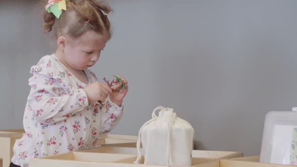 Little girl playing with toys at the local library.