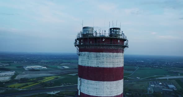 Aerial view on the top of a chimney, camera moving upwards.