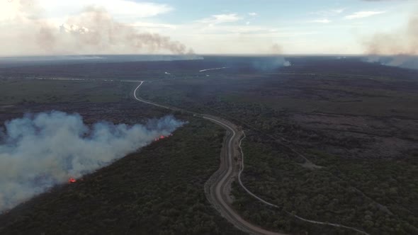 Aerial view of a wildfire burning short vegetation, Cambodia.